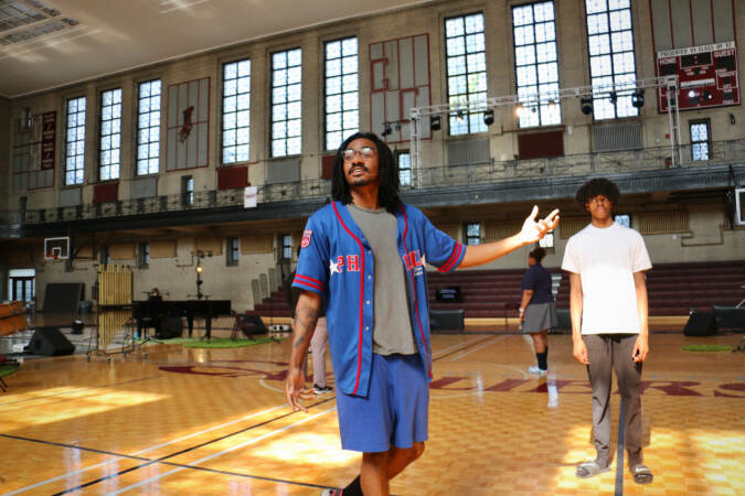 David Gaines performers in the middle of the basketball court.