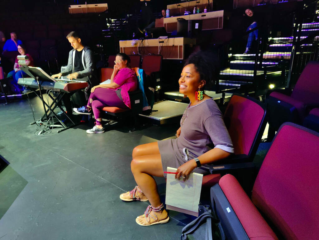 Amina Robinson looks on as she directs during a rehearsal.