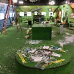 Shattered glass is everywhere on the floor of a large room.