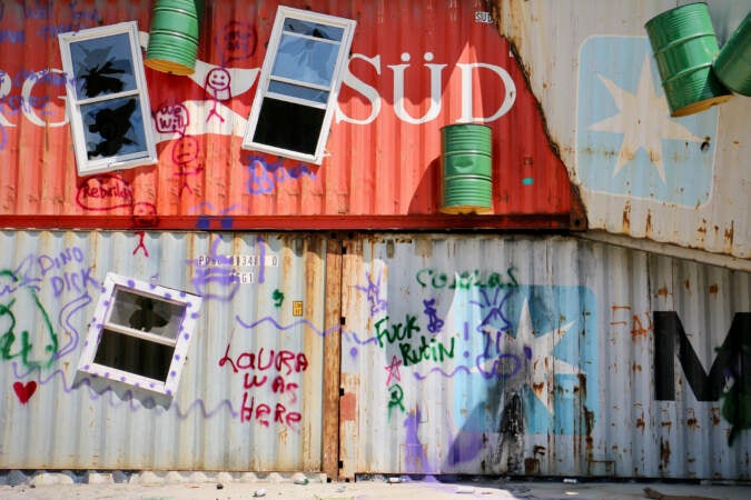 Graffiti is visible on the side of a building.