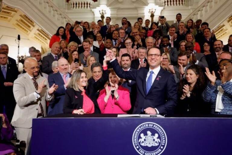 Pa. Gov. Josh Shapiro holds up Senate President Pro Tempore Kim Ward's hand as he signs the first bill of his tenure.
(