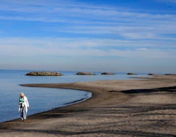 Alice Coughlin of Fairview, Pa. takes a Saturday morning walk along the shore of Lake Erie in Erie, Pa.