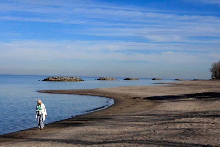 Alice Coughlin of Fairview, Pa. takes a Saturday morning walk along the shore of Lake Erie in Erie, Pa.