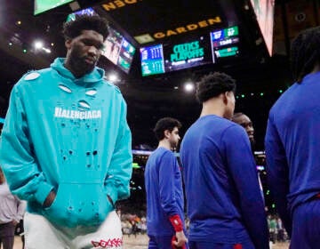 Philadelphia 76ers center Joel Embiid (left) walks on the court during the beginning of the second half of Game 1 against the Boston Celtics in the NBA basketball Eastern Conference semifinals playoff series, Monday, May 1, 2023, in Boston