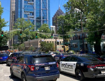 Emergency vehicles arrive on West Peachtree in Atlanta on Wednesday, May 3, 2023