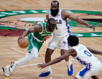 Boston Celtics guard Jaylen Brown (left) drives between Philadelphia 76ers' James Harden and Tyrese Maxey (0) during the first half of Game 2 in the NBA basketball Eastern Conference semifinals playoff series, Wednesdayv