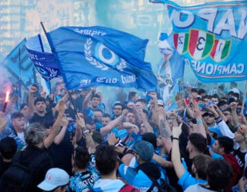 Napoli fans cheer in front of the Diego Armando Maradona stadium, in Naples, Italy