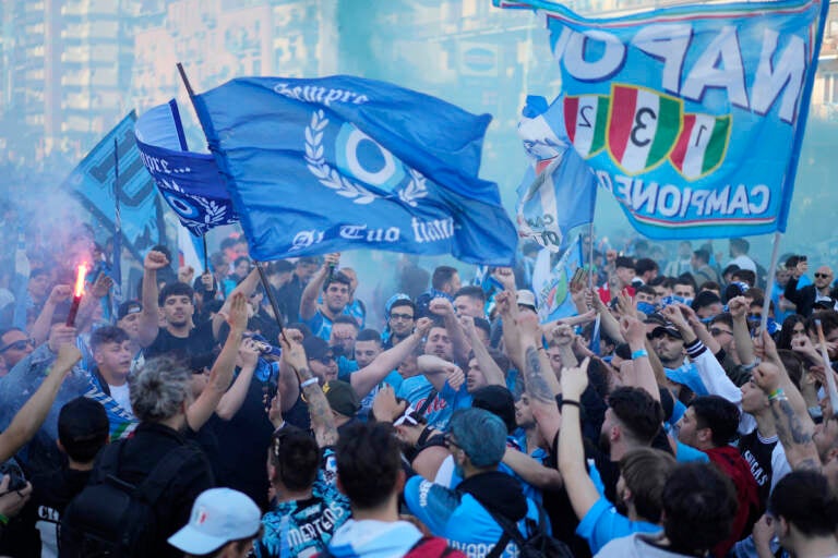 Napoli fans cheer in front of the Diego Armando Maradona stadium, in Naples, Italy