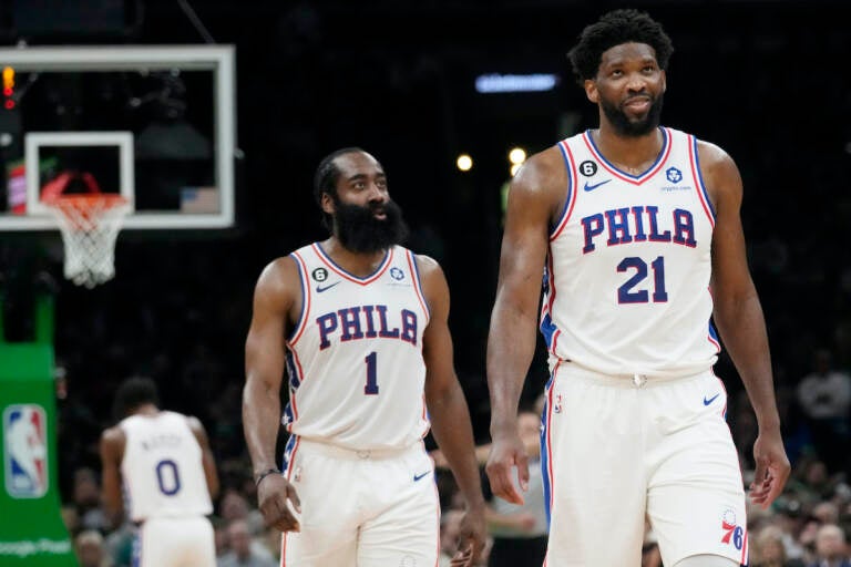 Philadelphia 76ers center Joel Embiid (21) smiles while walking down court with James Harden (1) during the second half of Game 5 in the NBA basketball Eastern Conference semifinals playoff series against the Boston Celtics