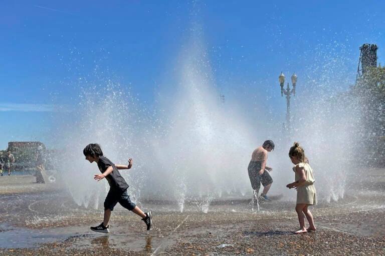 Children play in a fountain to cool off in downtown Portland, Ore., Friday, May 12, 2023. An early May heat wave this weekend could surpass daily records in parts of the Pacific Northwest and worsen wildfires already burning in western Canada, a historically temperate region that has grappled with scorching summer temperatures and unprecedented wildfires fueled by climate change in recent years. 
(AP Photo/Claire Rush)