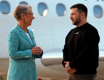 Ukrainian President Volodymyr Zelenskyy is welcomed by French Prime minister Elisabeth Borne upon his arrival at Villacoublay Air Base, southwest of Paris, Sunday, May 14, 2023. Ukrainian President Volodymyr Zelenskyy makes a surprise visit to Paris for talks Sunday night with French President Emmanuel Macron, extending a multi-stop European tour that has elicited fresh pledges of military support as his country gears up for a counteroffensive against Russian occupation forces. 
(Thomas Samson, Pool via AP)