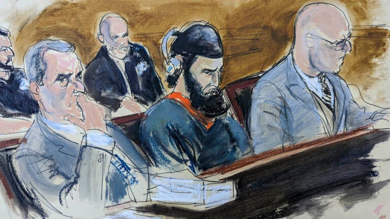 In this courtroom sketch, in federal court in New York, Wednesday, May 17, 2023, Sayfullo Saipov, center, is flanked by his attorneys, David M. Stern (left) and federal Defender Andrew John Dalack, right, during victim impact statements in the sentencing phase of his trial. Saipov, an Islamic extremist who killed eight in a New York bike path attack, was convicted of federal crimes, Jan. 26 2023