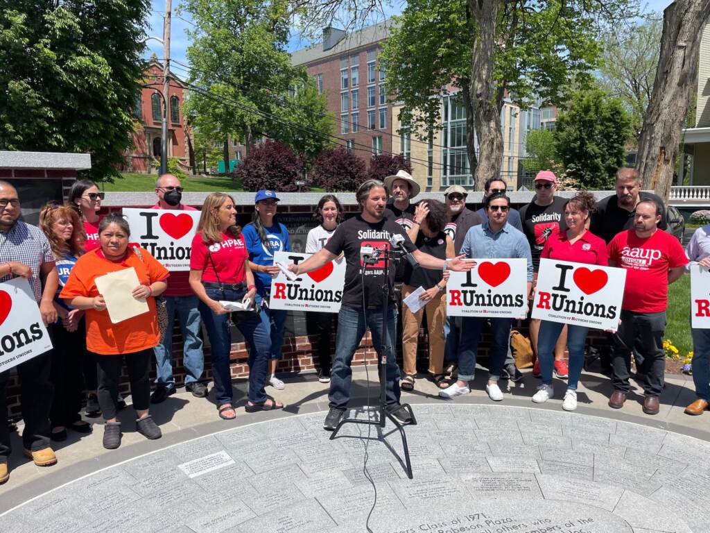 Rutgers AAUP-AFT General Vice President Todd Wolfson (at microphone) with members of several unions celebrating a ratified agreement with educators, researchers and clinicians. They are calling on university to settle contracts with other unions still at the bargaining table.