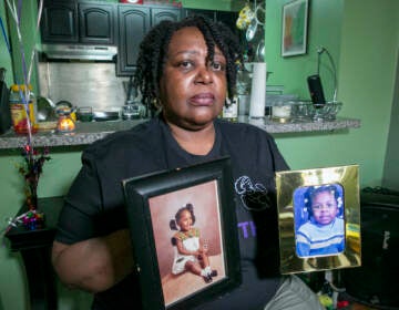 Joyce McMillan shows pictures of her children at her home in the Harlem neighborhood of New York City on Monday, May 15, 2023. The city's child protective services removed her two daughters from her custody 23 years ago after an investigation discovered an illicit substance in her body.  McMillan is the founder of the advocacy group JMACforFamilies and is now an advocate pushing for reforms to the child welfare system.    (AP Photo/Ted Shaffrey)