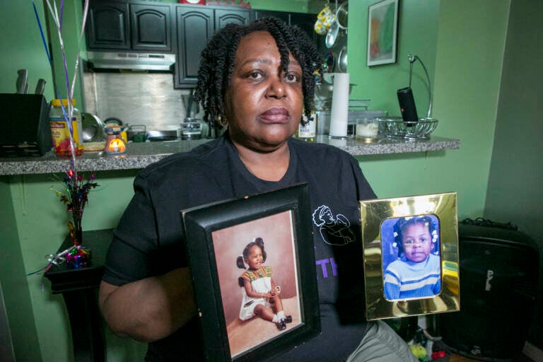 Joyce McMillan shows pictures of her children at her home in the Harlem neighborhood of New York City on Monday, May 15, 2023. The city's child protective services removed her two daughters from her custody 23 years ago after an investigation discovered an illicit substance in her body.  McMillan is the founder of the advocacy group JMACforFamilies and is now an advocate pushing for reforms to the child welfare system.    (AP Photo/Ted Shaffrey)