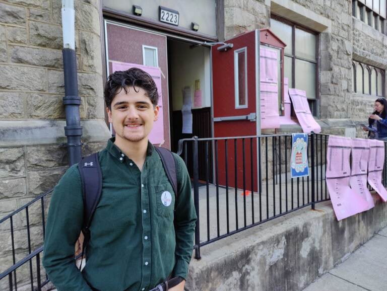 Adam Hoover poses outside of his polling place on election day.