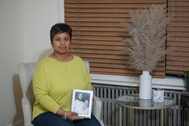 Tamika Morales holds a photo of herself and her son, Ahmad Morales.