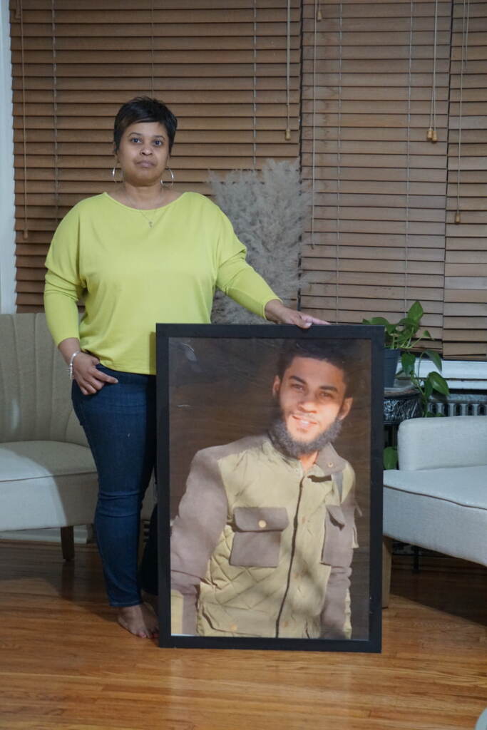 Tamika Morales holds a photo of her son, Ahmad Morales.