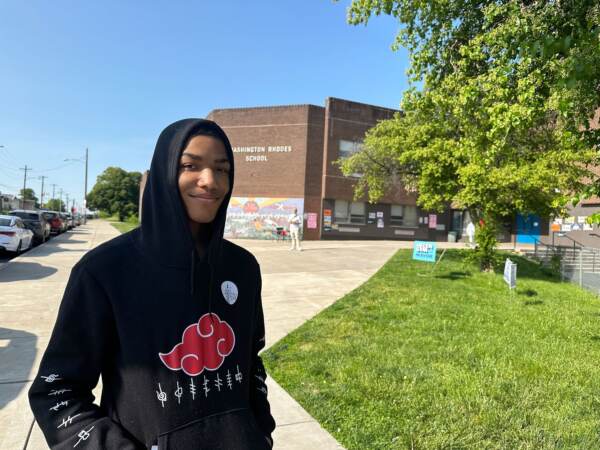 Amir Cooper standing outside of a polling place on election day.