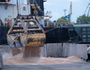 Workers load grain at a port in Izmail, Ukraine, on April 26. A United Nations-backed deal has been extended allowing shipments of Ukrainian grain through the Black Sea to parts of the world struggling with hunger.