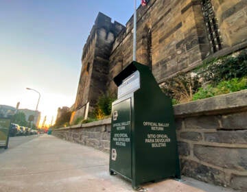 A mail ballot drop box is visible in front of the Eastern State Penitentiary.