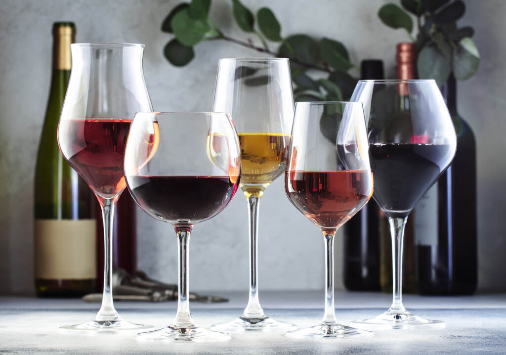 An array of wine glasses with different kinds of wine