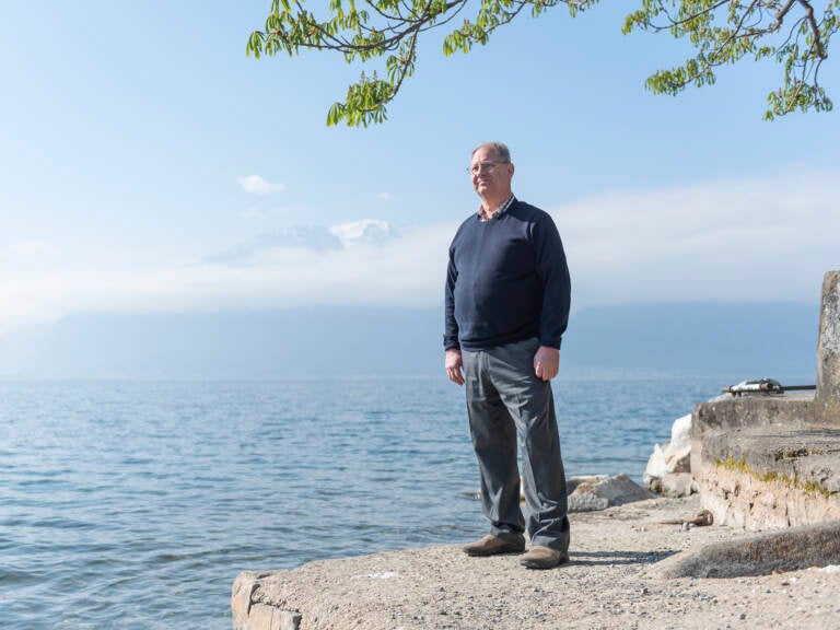 Jay Comfort standing on a cliff overlooking the ocean.