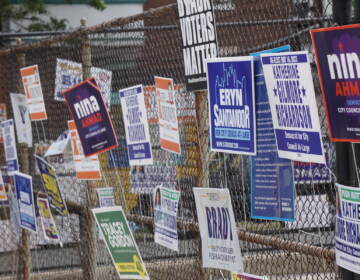 Campaign signs on a fence