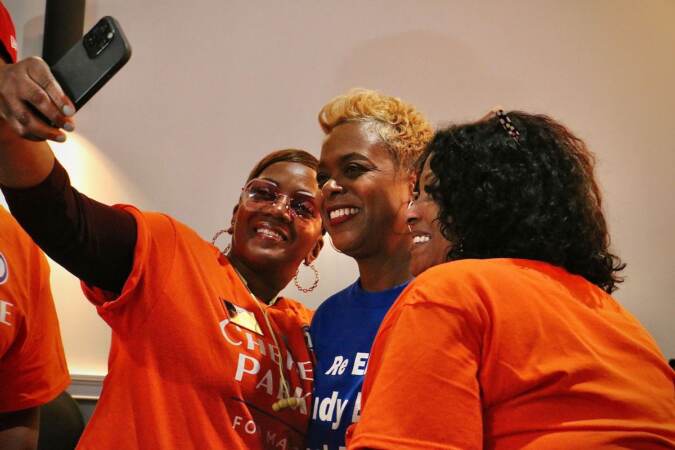 Philadelphia City Councilmember Cindy Bass takes a selfie with supporters at Cherelle Parker’s election watch party. (Emma Lee/WHYY)