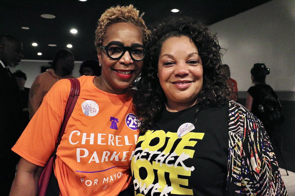Dr. Argie Allen-Wilson (left), cofounder of Mental Health First Connects, and Catherine Hicks, publisher of the Philadelphia Sunday Sun and president of the Philadelphia NAACP, celebrate Cherelle Parker’s victory in the Democratic mayoral primary at Laborers Local 332 headquarters. (Emma Lee/WHYY)