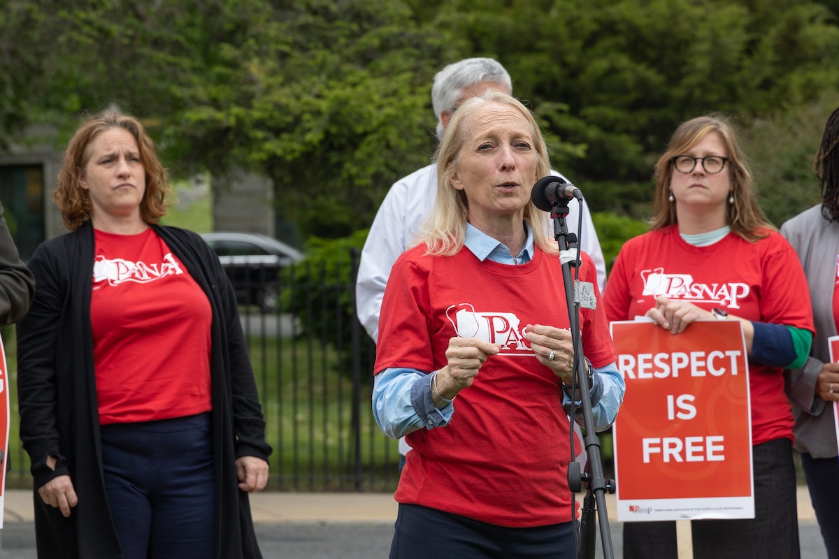 U.S. Congresswoman Mary Gay Scanlon speaks at a microphone at a protest.