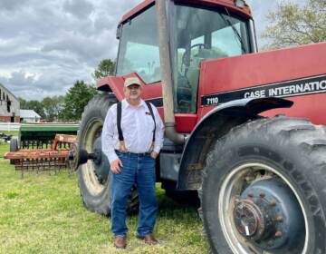 William Donald Clifton stands by a tractor trailer on his farm.