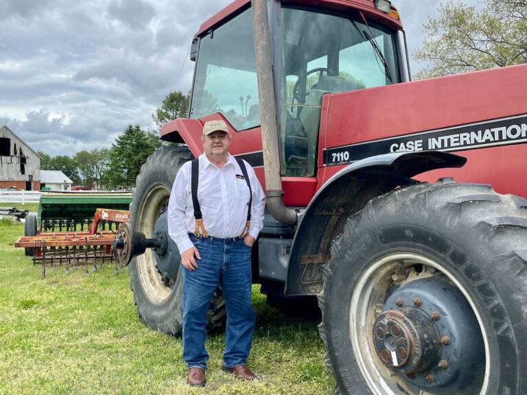 William Donald Clifton stands by a tractor trailer on his farm.