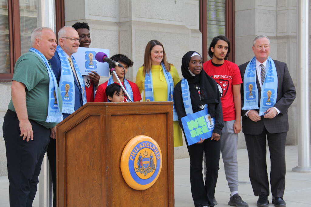 Meg Kane, members of a youth soccer team, Mayor Jim Kenney, and other officials pose for a photo outside of City Hall.