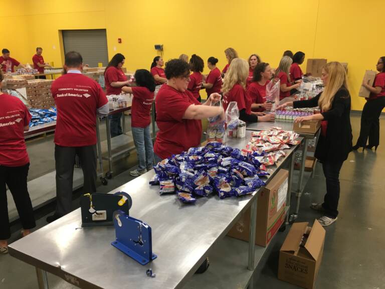 Volunteers sorting food at a food bank.