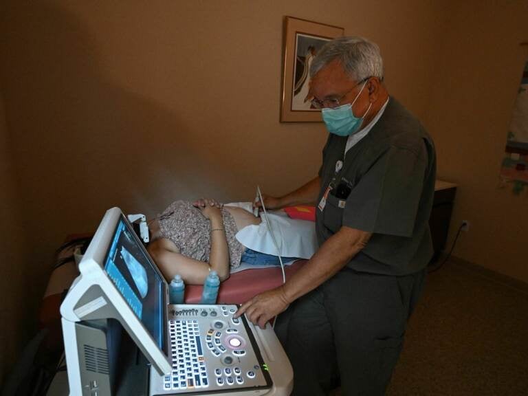Dr Franz Theard performs a sonogram to confirm pregnancy on a patient seeking abortion services at the Women's Reproductive Clinic, which provides legal medication abortion services, in Santa Teresa, New Mexico, on June 15, 2022. - In the wake of Friday's ruling by the US Supreme Court striking down Roe v Wade and the federally protected right to an abortion, women from Texas and other states are traveling to clinics like the Women's Reproductive Health Clinic in New Mexico for legal abortion services under the state's more liberal laws. - RESTRICTED TO EDITORIAL USE (Photo by Robyn Beck / AFP) / RESTRICTED TO EDITORIAL USE (Photo by ROBYN BECK/AFP via Getty Images)