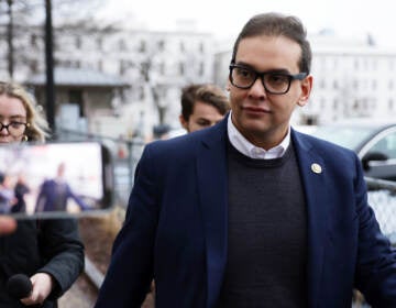 U.S. Rep. George Santos leaves the Capitol Hill Club as members of the press follow him on Jan. 31 in Washington, D.C., amid ongoing investigations into his finances, campaign spending and false statements on the campaign trail.