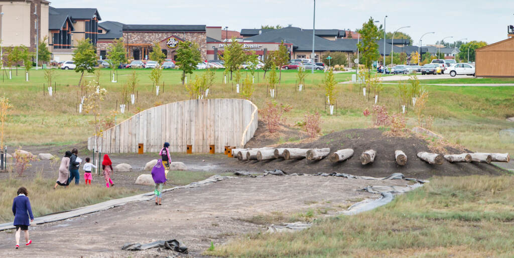 People gather in an open place that is also a sound garden. 