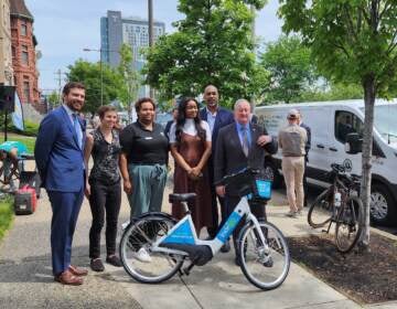 Officials posing at a press conference for the newest Bike share station.