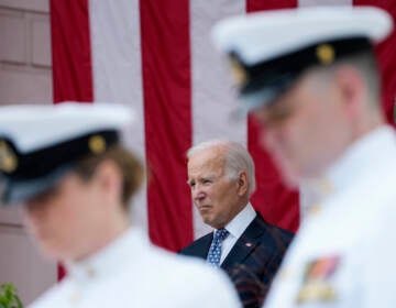 President Joe Biden stands with Defense Secretary Lloyd Austin as the national anthem is played at the Memorial Amphitheater of Arlington National Cemetery