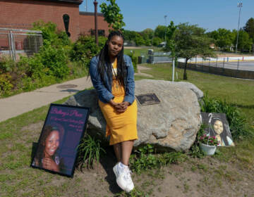 Lakeisha Lee placed flowers at the base of a monument honoring her late sister Brittany Clardy Thursday, May 26, in Saint Paul. Clardy went missing more than a decade ago and was found murdered.
(Dana Ferguson/MPR News)