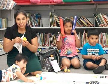 Magali Vicente-Ortega and her three children pose for a photo.