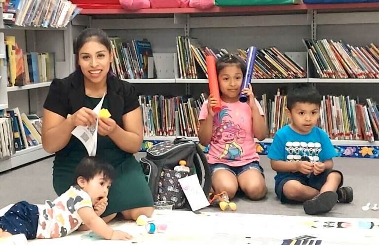 Magali Vicente-Ortega and her three children pose for a photo.