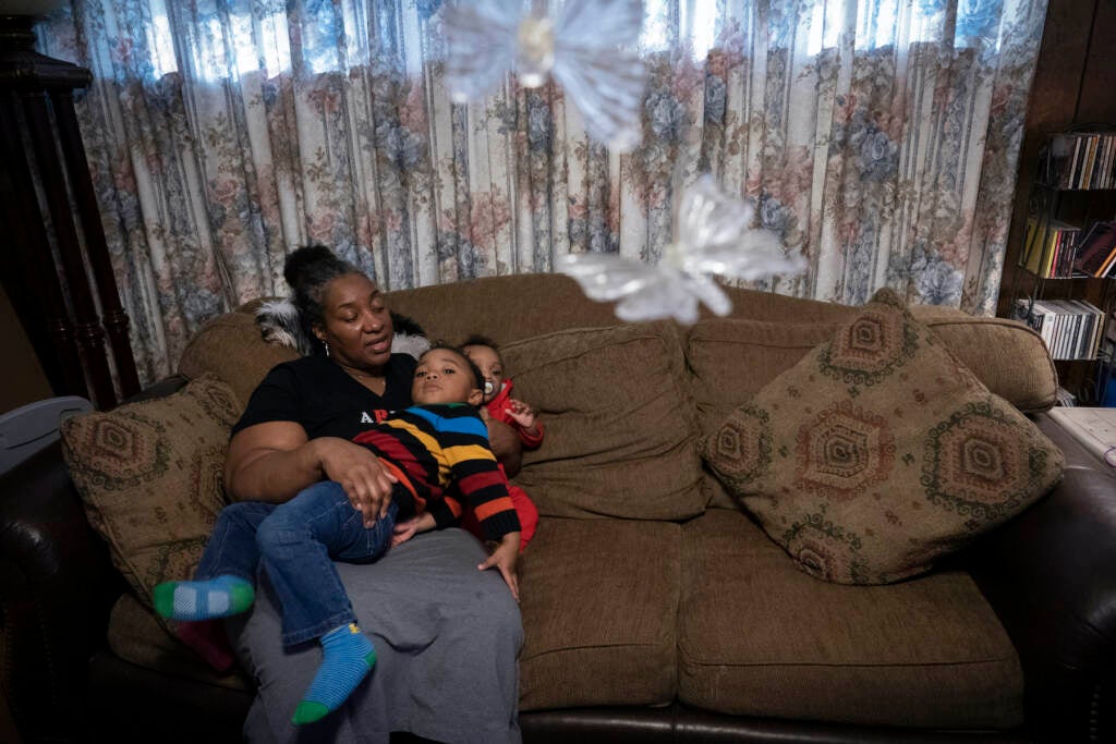 Shelonda Lyons on the couch with her grandchildren