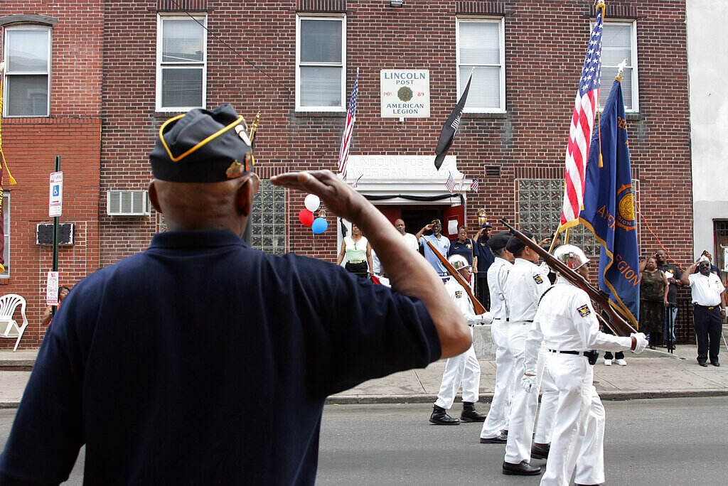 Tom Bell, Lincoln Post Service Officer, salutes as the flag goes by in the All Wars Memorial & Lincoln American Legion Memorial Day Parade in Philadelphia on Sunday, May 28, 2006. 