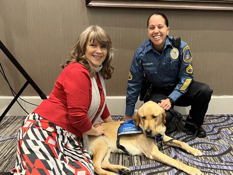 Family Court Judge Jennifer Ranji (left) with Capitol Police officer Donna DiClemente and Vinn, the 2-year-old lab mix that the judge uses when interviewing children in custody or other cases to make them less nervous