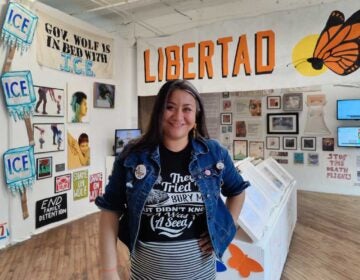 Jasmine Rivera stands in the middle of an art exhibition space.