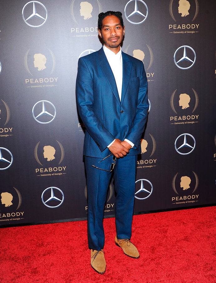 Terence Nance poses for a photo on a red carpet.