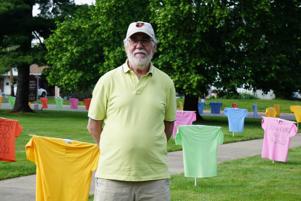 Bryan Miller standing outside by the t-shirt memorial