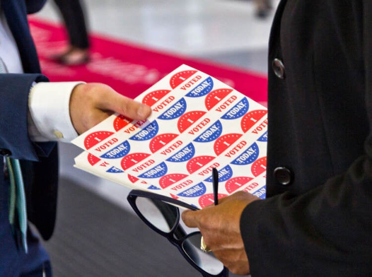 An election worker holds I Voted stickers